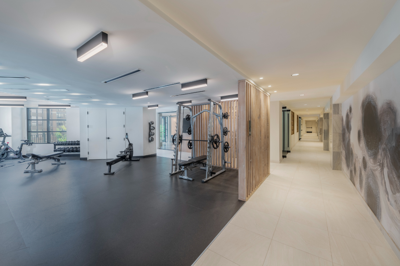 Gym Room with treadmills and stair masters and a hallway