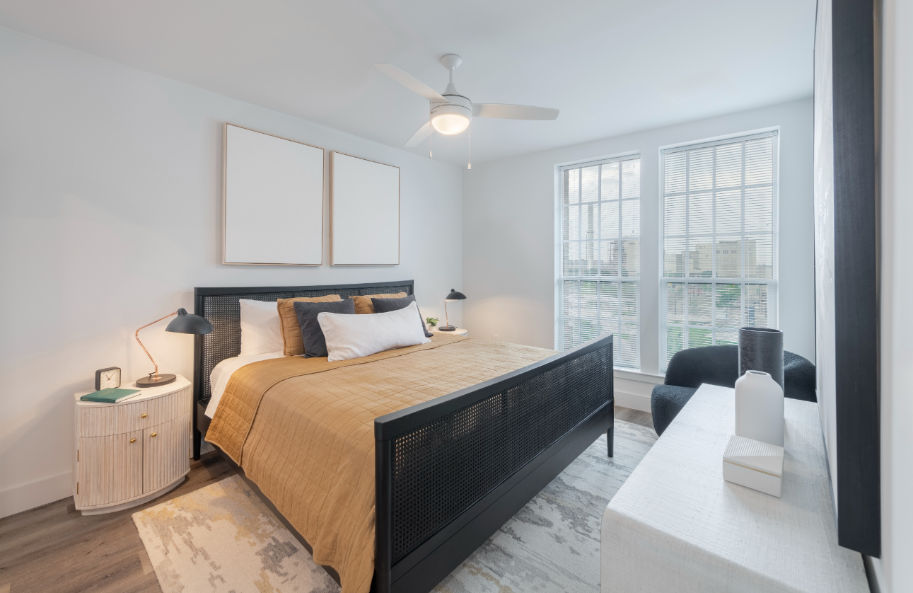 Bedroom with plush bed and ceiling fan